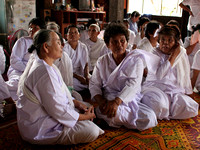 Ladies dressed in white for a young man's ordination